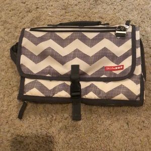 Baby clutch with a detachable diaper changing pad